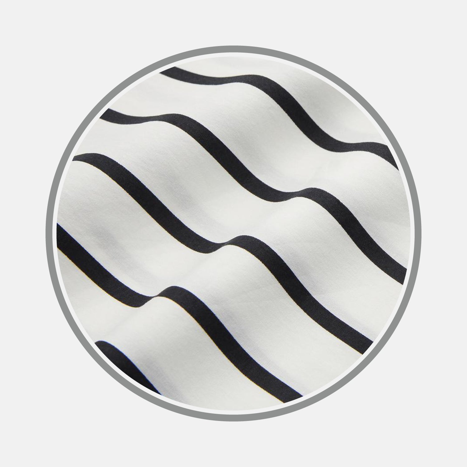 View 1 of product A close-up of Turnbull & Asser's Black & White Wide Stripe Cotton Fabric, featuring evenly spaced wavy black stripes on white, displayed in a circular frame against a plain background.