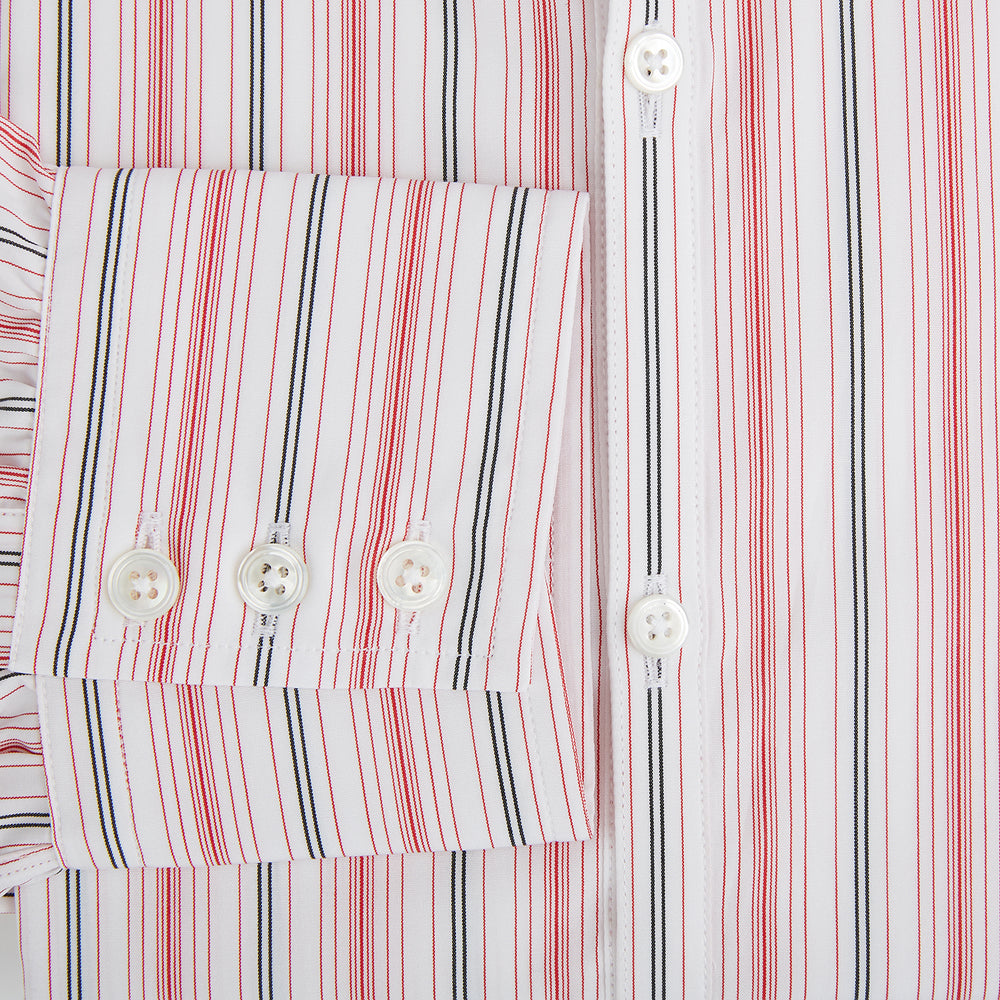The Red Multi Pencil Stripe Windsor Shirt by Turnbull & Asser features long sleeves, buttoned cuffs, a Turnbull collar, and classic British tailoring with vertical red, pink, and white stripes.