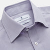 View 2 of product The Turnbull & Asser Lilac Silk Regular Fit Flaxton Shirt features long sleeves, a classic collar, white buttons, and a curved hem, shown laid flat on a white background.