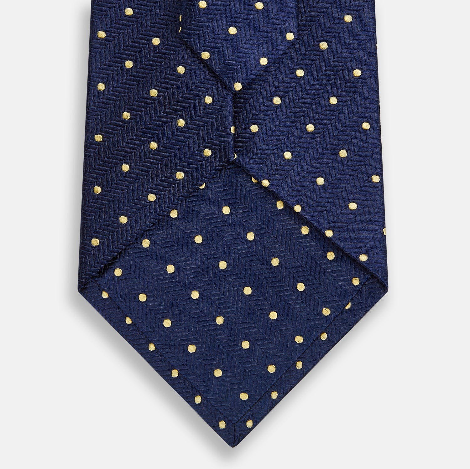 View 3 of product The Turnbull & Asser Navy and Gold Micro Dot Silk Tie showcases subtle herringbone texture with gold micro dots, offering a refined and modern look for the office.