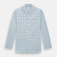 The Turnbull & Asser Green and Blue Check Pyjama Shirt features long sleeves and a button-up design on a white base, offering elegant loungewear style. Shown laid flat against a white background.