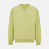 View 1 of product The Turnbull & Asser Melon Green Cashmere V-Neck Jumper features long sleeves with ribbed cuffs and hem, shown against a plain white background.