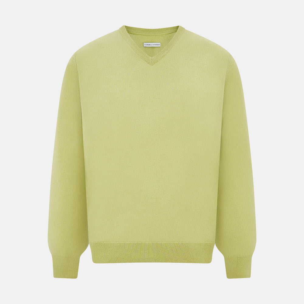 The Turnbull & Asser Melon Green Cashmere V-Neck Jumper features long sleeves with ribbed cuffs and hem, shown against a plain white background.