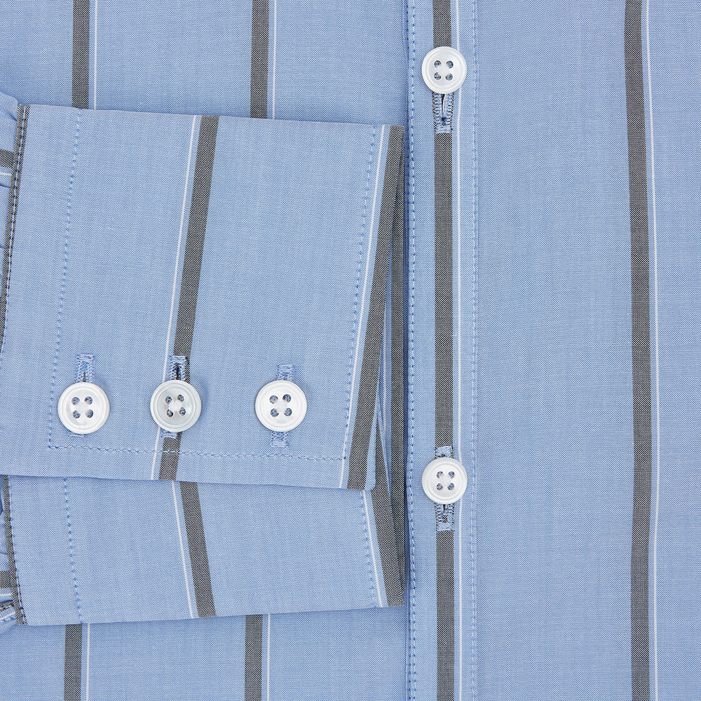 The Sky Blue Track Stripe Westminster Shirt by Turnbull & Asser features long sleeves, a Turnbull collar, and vertical dark blue and white stripes, displayed flat on a white surface.