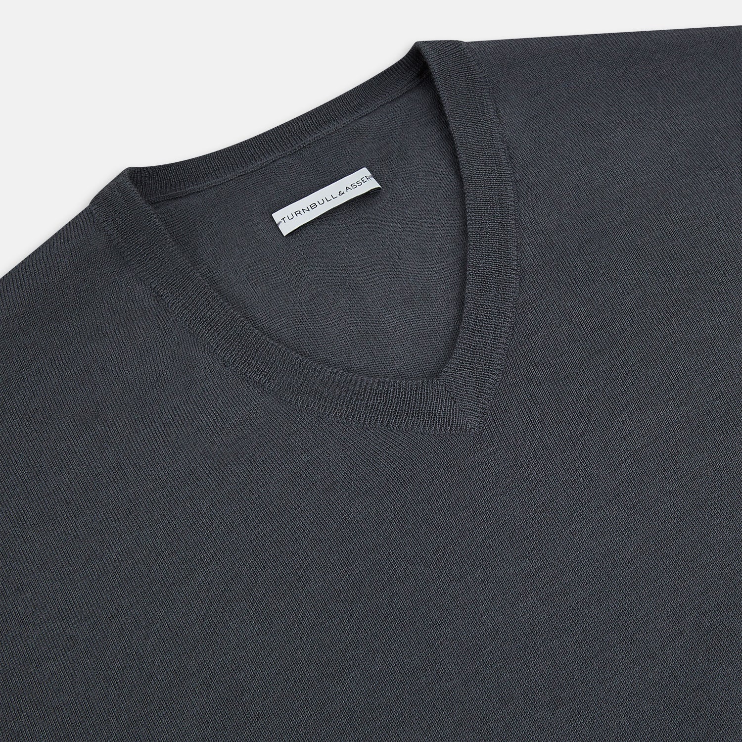 View 2 of product The Turnbull & Asser Charcoal Grey Merino V-Neck Jumper is shown against a white background, featuring long sleeves, a relaxed fit, and ribbed cuffs and hem for comfort.