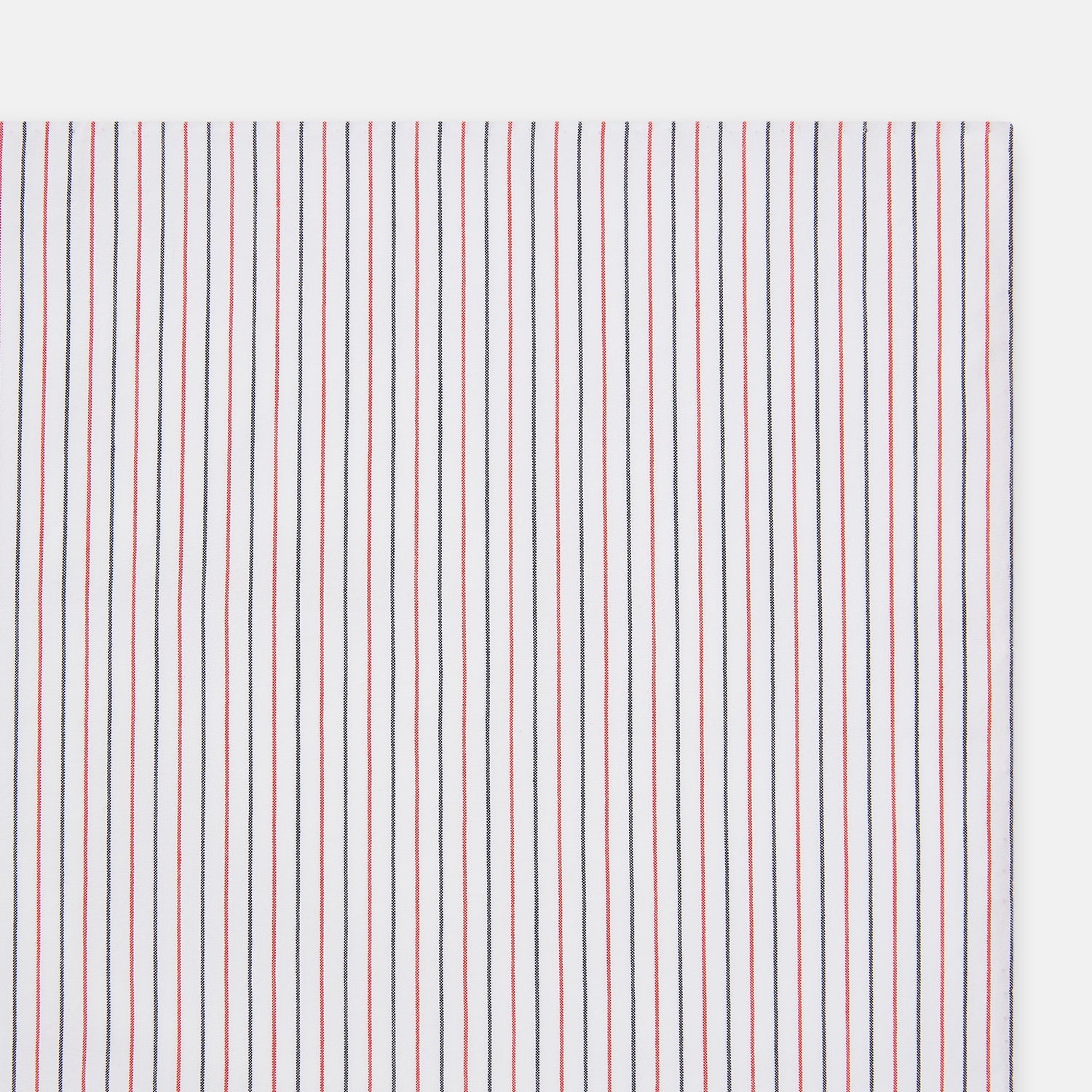 View 2 of product The Turnbull & Asser Hand Rolled Red and Navy Pinstripe Handkerchief features evenly spaced vertical stripes on white cotton, offering a clean, classic look as an elegant gentleman's accessory or stylish pocket square.