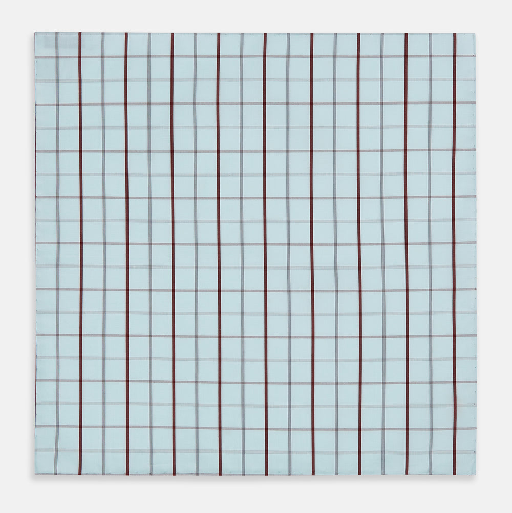 The Turnbull & Asser Burgundy Combination Check Hand-Rolled Handkerchief, featuring a light blue plaid with thin gray lines and bold dark red stripes, is displayed flat against a white background.