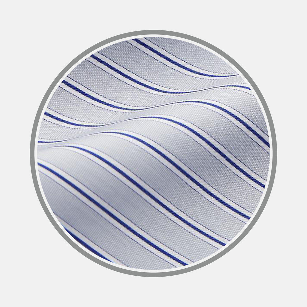 Close-up of Turnbull & Asser's Navy & Blue Stripe Cotton Fabric, featuring thin wavy blue stripes and a slightly textured white surface, displayed in a circular frame against a plain background.