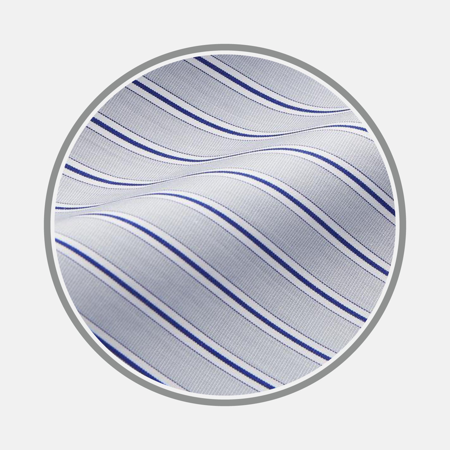 View 1 of product Close-up of Turnbull & Asser's Navy & Blue Stripe Cotton Fabric, featuring thin wavy blue stripes and a slightly textured white surface, displayed in a circular frame against a plain background.