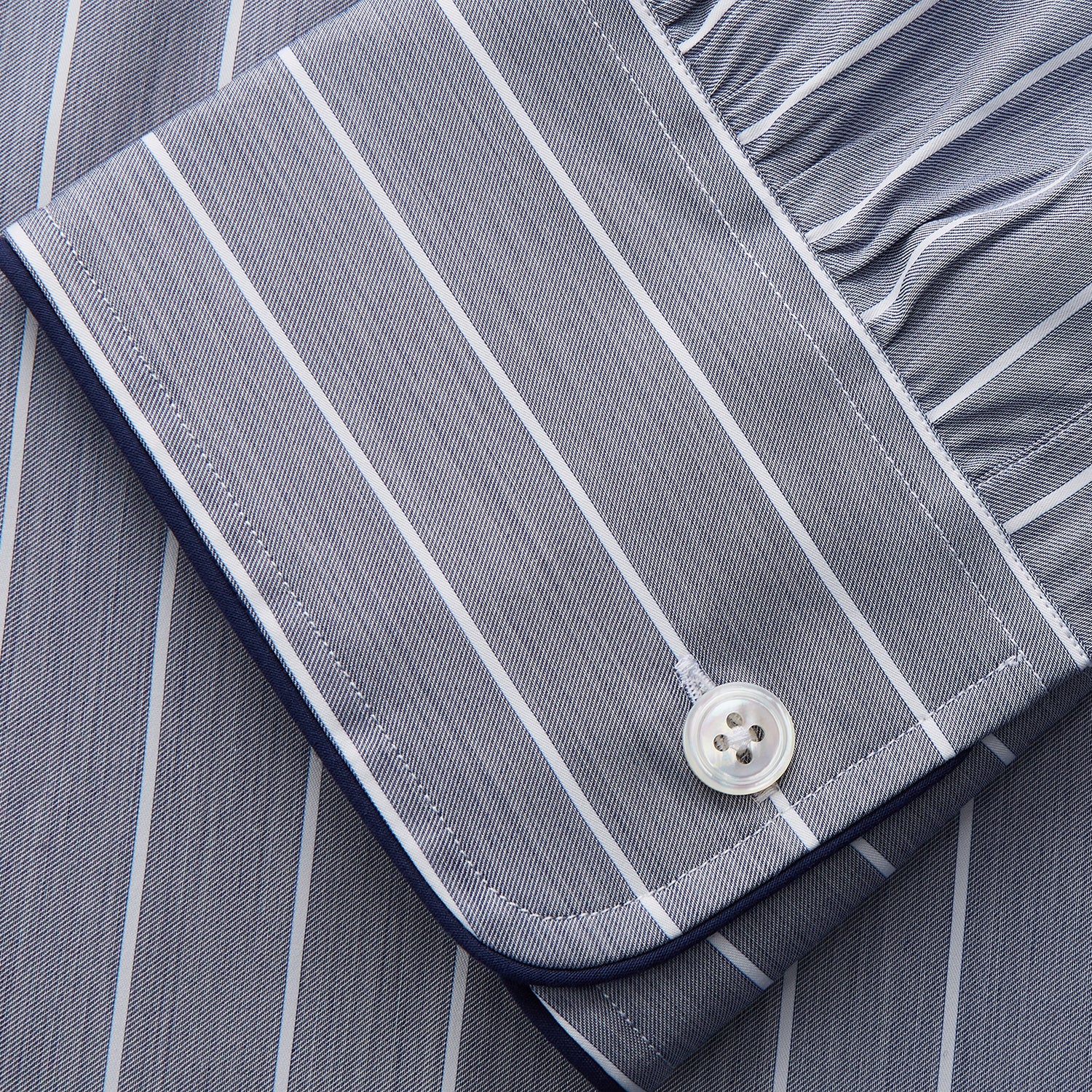 View 3 of product The Turnbull & Asser Pale Blue and White Pinstripe Cotton Blend Sussex Nightshirt pairs classic style with comfort, featuring long sleeves, a collar, front buttons, chest pocket, and curved hemline—perfect for luxury sleepwear.