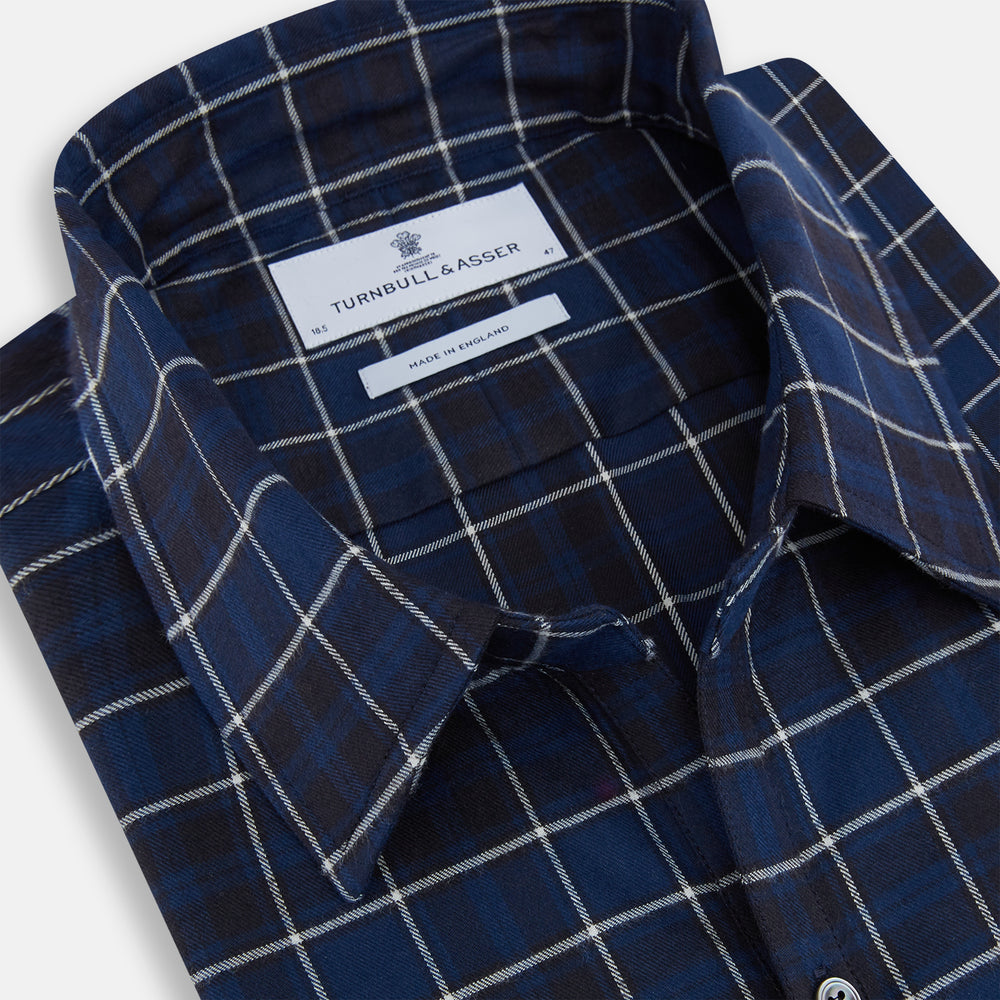 The Turnbull & Asser Navy and White Check Windsor Shirt features a long-sleeve design with a navy base and white check pattern, showcasing British craftsmanship and displayed on a white background.