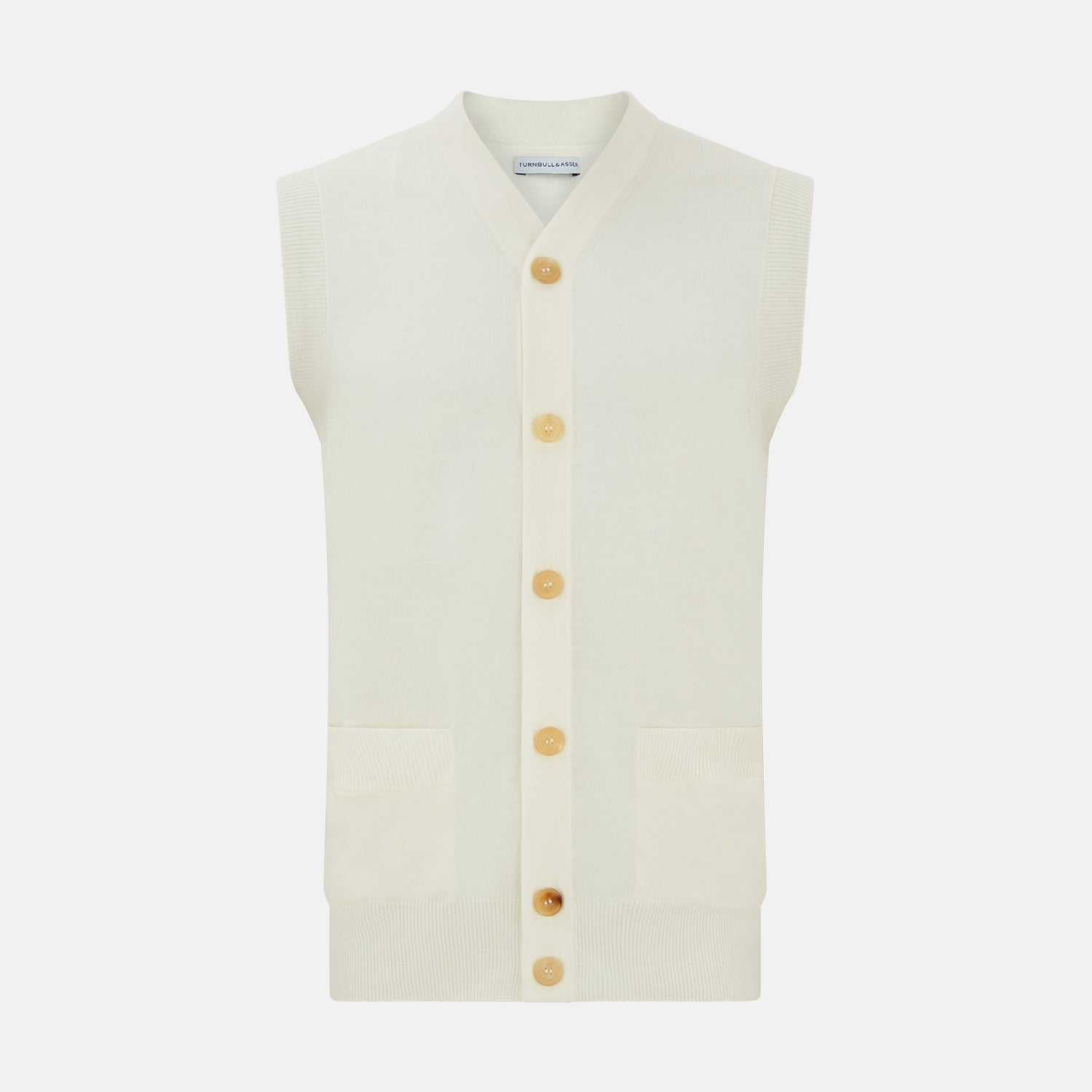 View 1 of product The Ecru Fine Merino V-Neck Sleeveless Cardigan from Turnbull & Asser features a front button closure with five light brown buttons and two pockets. Soft, lightweight, and ideal for gentlemanly layering in cooler seasons.