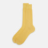 View 2 of product The Turnbull & Asser Banana Mid-Length Sock, made from mercerised Egyptian cotton with a hand-linked toe, is shown upright on a plain white background.