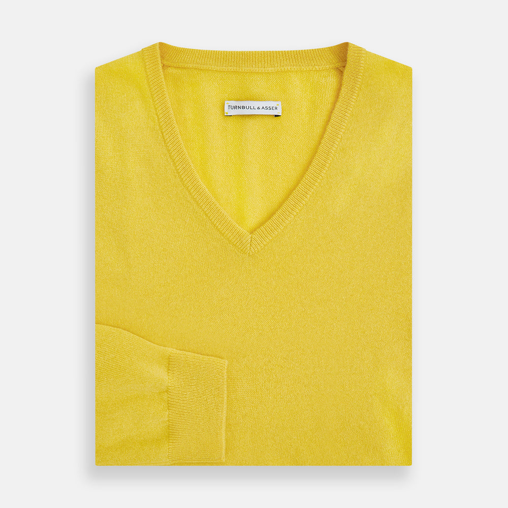 The Turnbull & Asser Canary Yellow Cashmere V-neck Jumper features long sleeves and ribbed cuffs and hem, shown against a white background.
