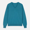 View 1 of product The Teal Paden V-Neck Jumper by Turnbull & Asser is a pure cashmere sweater in teal blue, featuring long sleeves with ribbed cuffs and hem, shown flat on a light gray background.