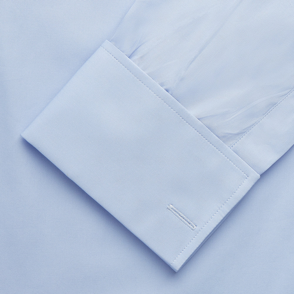 The Turnbull & Asser Tailored Fit Blue Cotton Shirt features a Kent collar and double cuffs—ideal for pairing with a navy suit for a sharp look.
