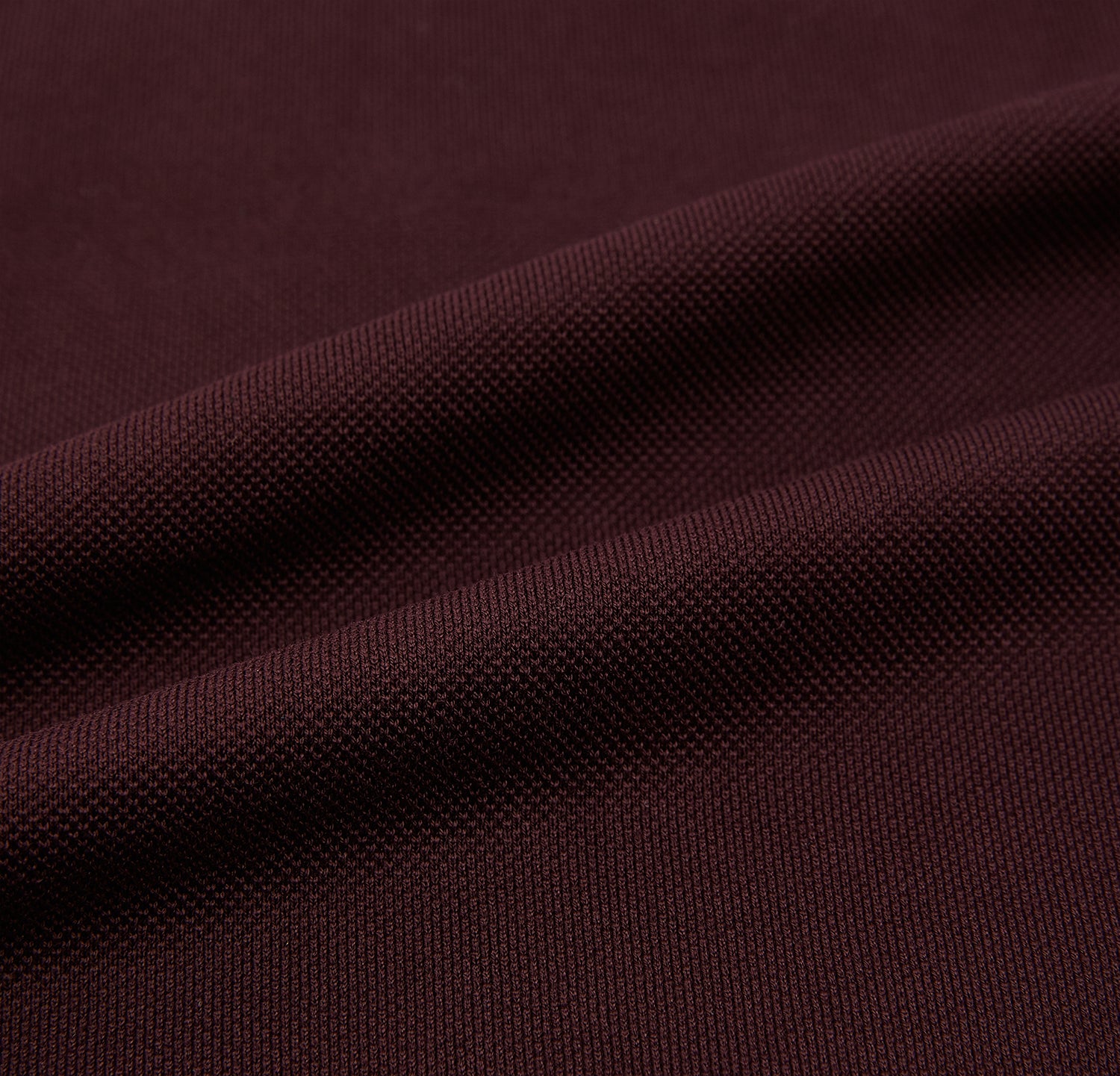 View 5 of product The Turnbull & Asser Burgundy Polo Shirt is crafted from soft cotton jersey with short sleeves, a classic collar, three front buttons, and a small buttoned chest pocket, shown flat on a white background.