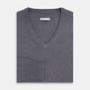 View 4 of product The Grey V-Neck Cashmere Jumper by Turnbull & Asser features long sleeves, ribbed cuffs and hem, in dark gray cashmere, shown against a white background.