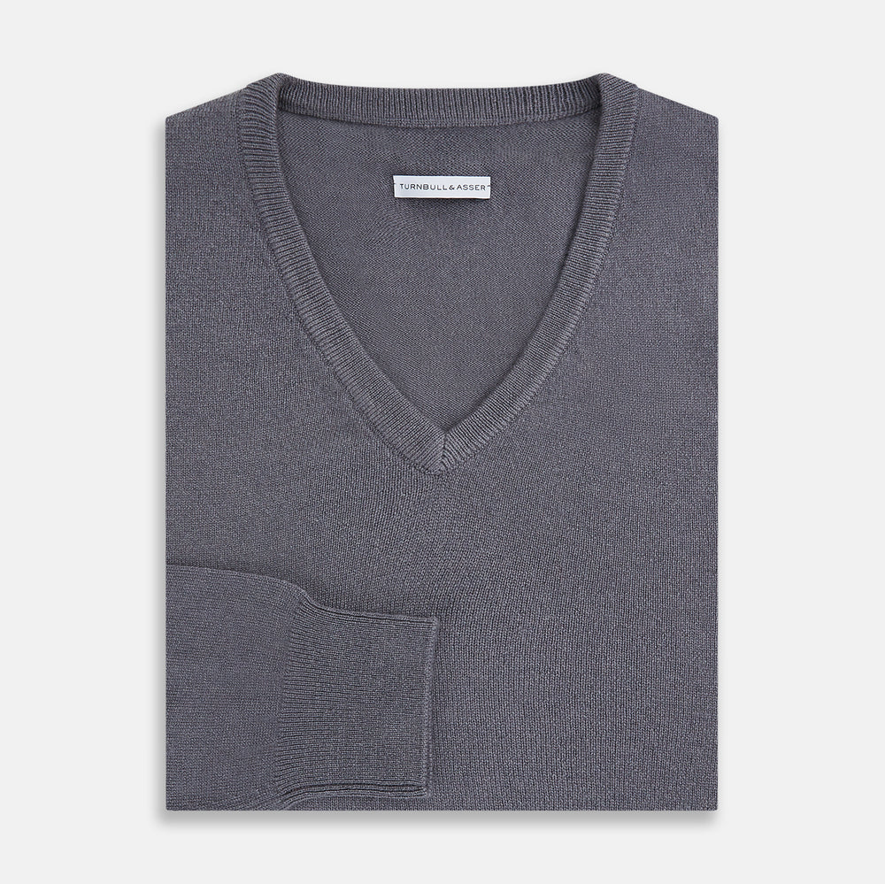 The Grey V-Neck Cashmere Jumper by Turnbull & Asser features long sleeves, ribbed cuffs and hem, in dark gray cashmere, shown against a white background.