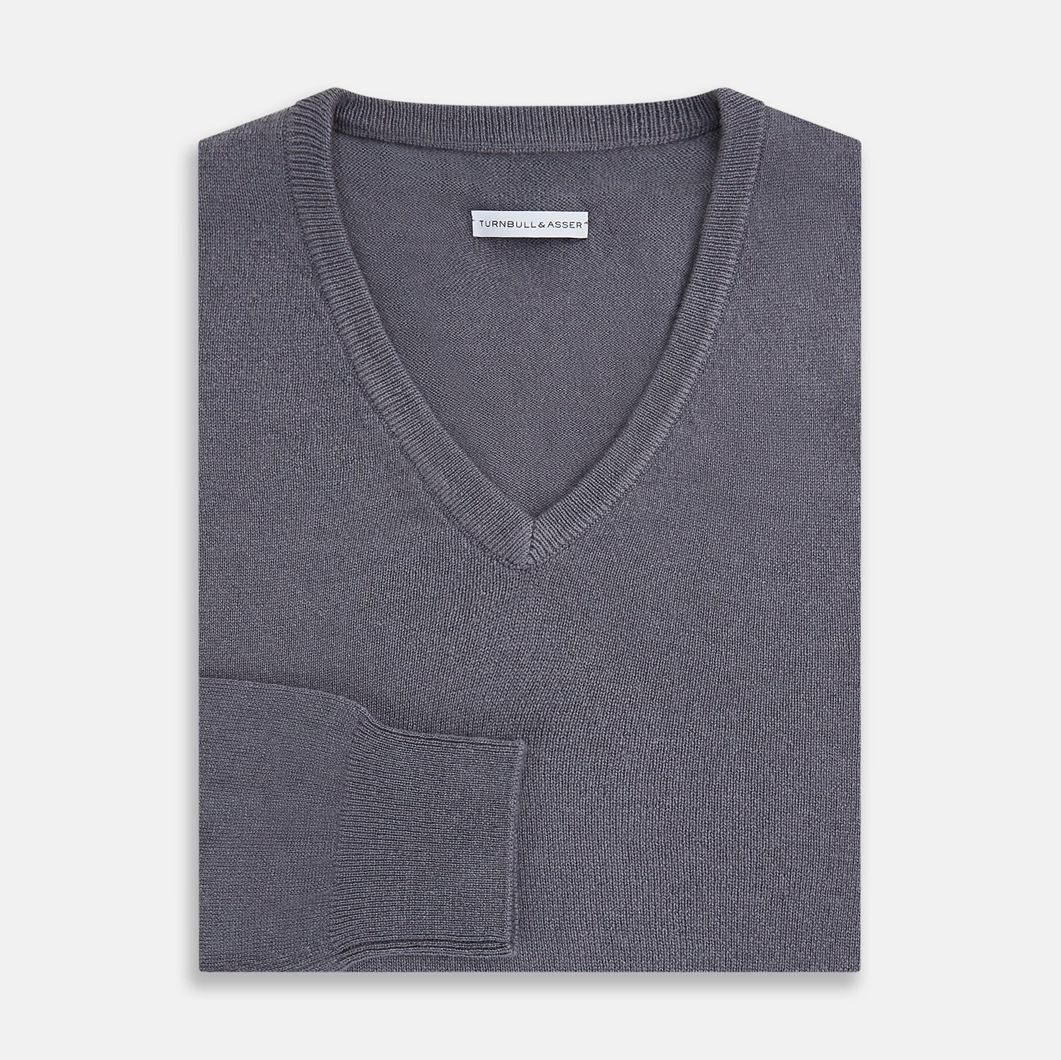 View 4 of product The Grey V-Neck Cashmere Jumper by Turnbull & Asser features long sleeves, ribbed cuffs and hem, in dark gray cashmere, shown against a white background.