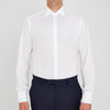 View 2 of product A neatly folded Turnbull & Asser Two-Fold 200 White Cotton Shirt with a Regent collar and 3-button cuffs, crafted from breathable fabric, is displayed on a light grey background with the label visible inside the collar.