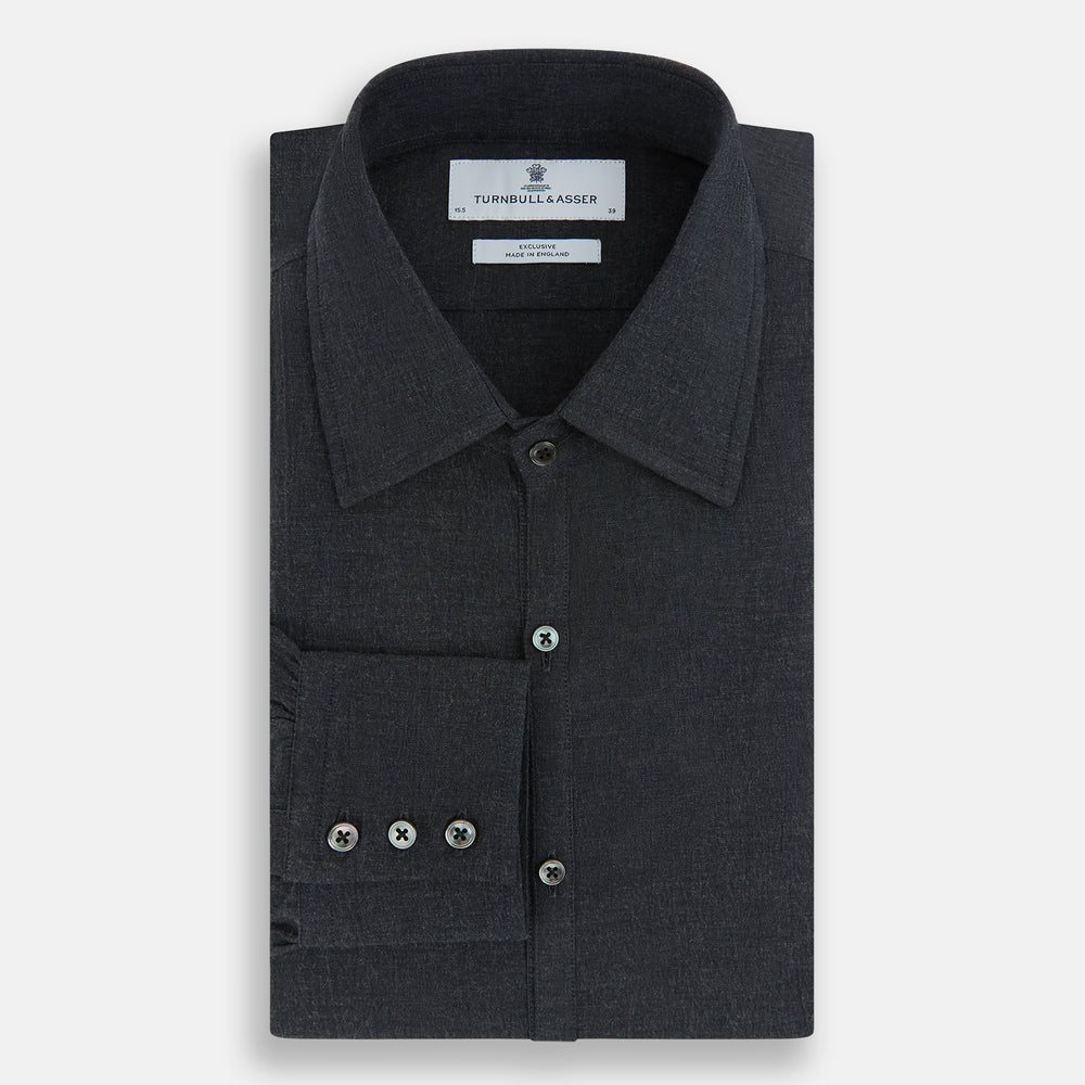 The Turnbull & Asser Midnight Blue Westminster Shirt features long sleeves, a button-up front, classic collar, and buttoned cuffs in a plain design—showcasing British craftsmanship—laid flat on a white background.