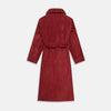 View 5 of product The Turnbull & Asser Burgundy Linen & Cotton Cord Gown, expertly made in England, features a shawl collar, patch pockets, and a matching fabric belt—shown here on a white background.