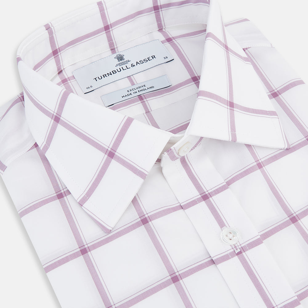 The Antique Pink Grid Check Mayfair Shirt by Turnbull & Asser is a long-sleeve shirt made from Italian cotton, featuring evenly spaced pink grid checks, displayed flat on a white background.