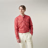 View 4 of product The Turnbull & Asser Plain Red Linen Weekend Fit Shirt with Stand Collar features long sleeves, a button-up front, and two buttoned-flap chest pockets. It is shown neatly laid flat on a plain light background.