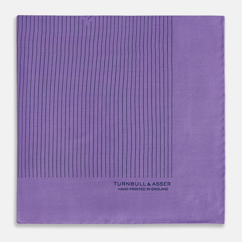 The Purple Stripe Silk Pocket Square by Turnbull & Asser features thin black lines on purple silk—a sophisticated blazer accessory hand printed in England, showcasing classic British craftsmanship.