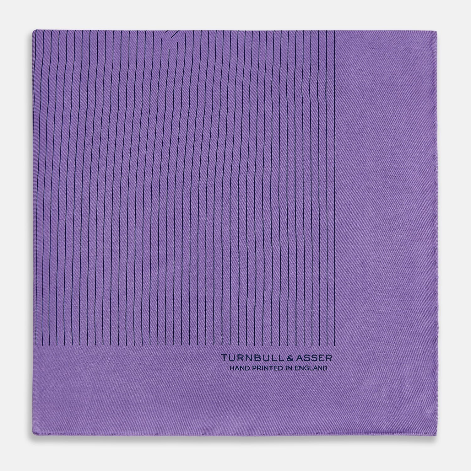 View 4 of product The Purple Stripe Silk Pocket Square by Turnbull & Asser features thin black lines on purple silk—a sophisticated blazer accessory hand printed in England, showcasing classic British craftsmanship.
