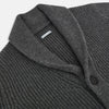 View 2 of product The Turnbull & Asser Shadow Grey Cashmere Shawl Collar Cardigan features ribbed detailing, a front button closure, and two front pockets, shown against a plain white background.