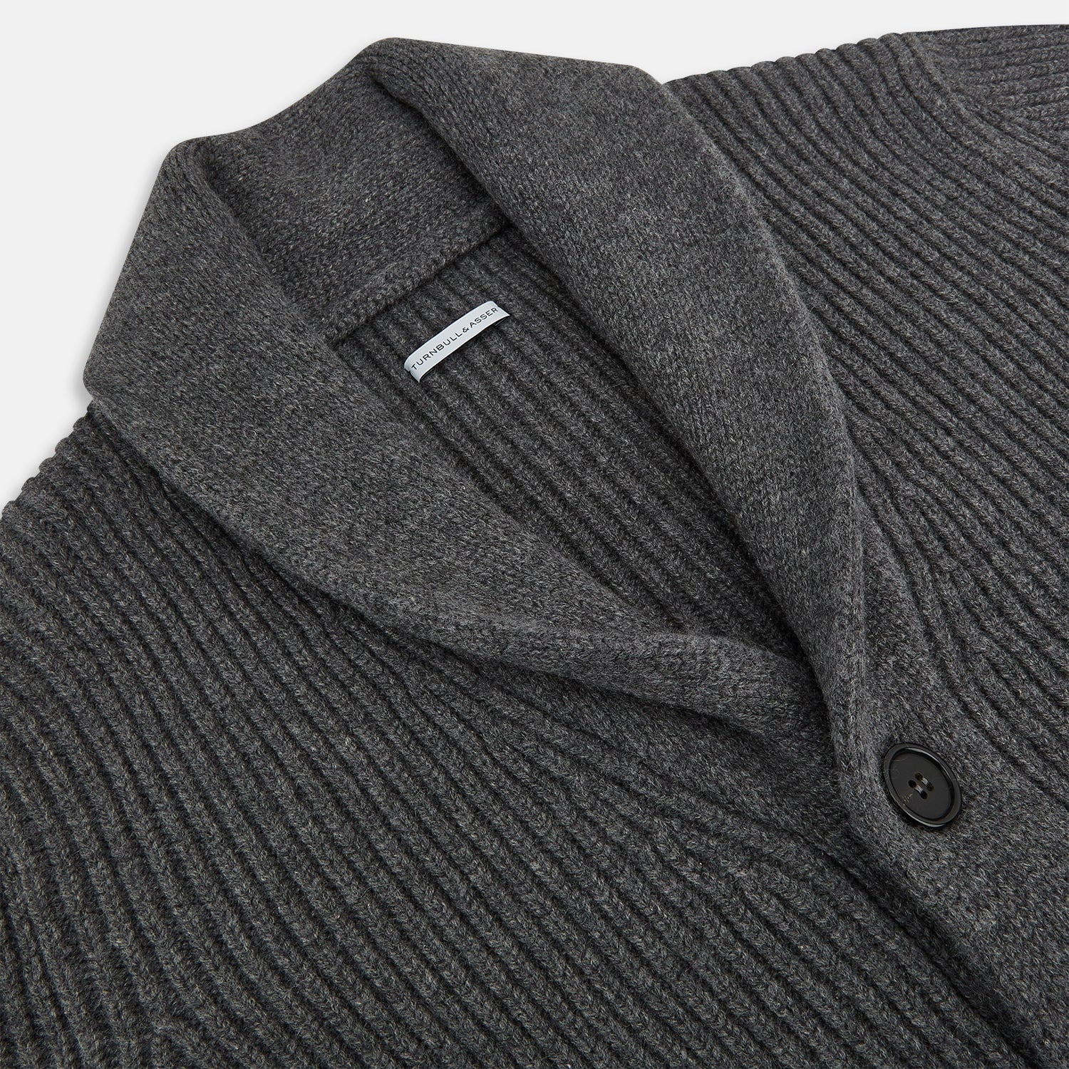 View 2 of product The Turnbull & Asser Shadow Grey Cashmere Shawl Collar Cardigan features ribbed detailing, a front button closure, and two front pockets, shown against a plain white background.