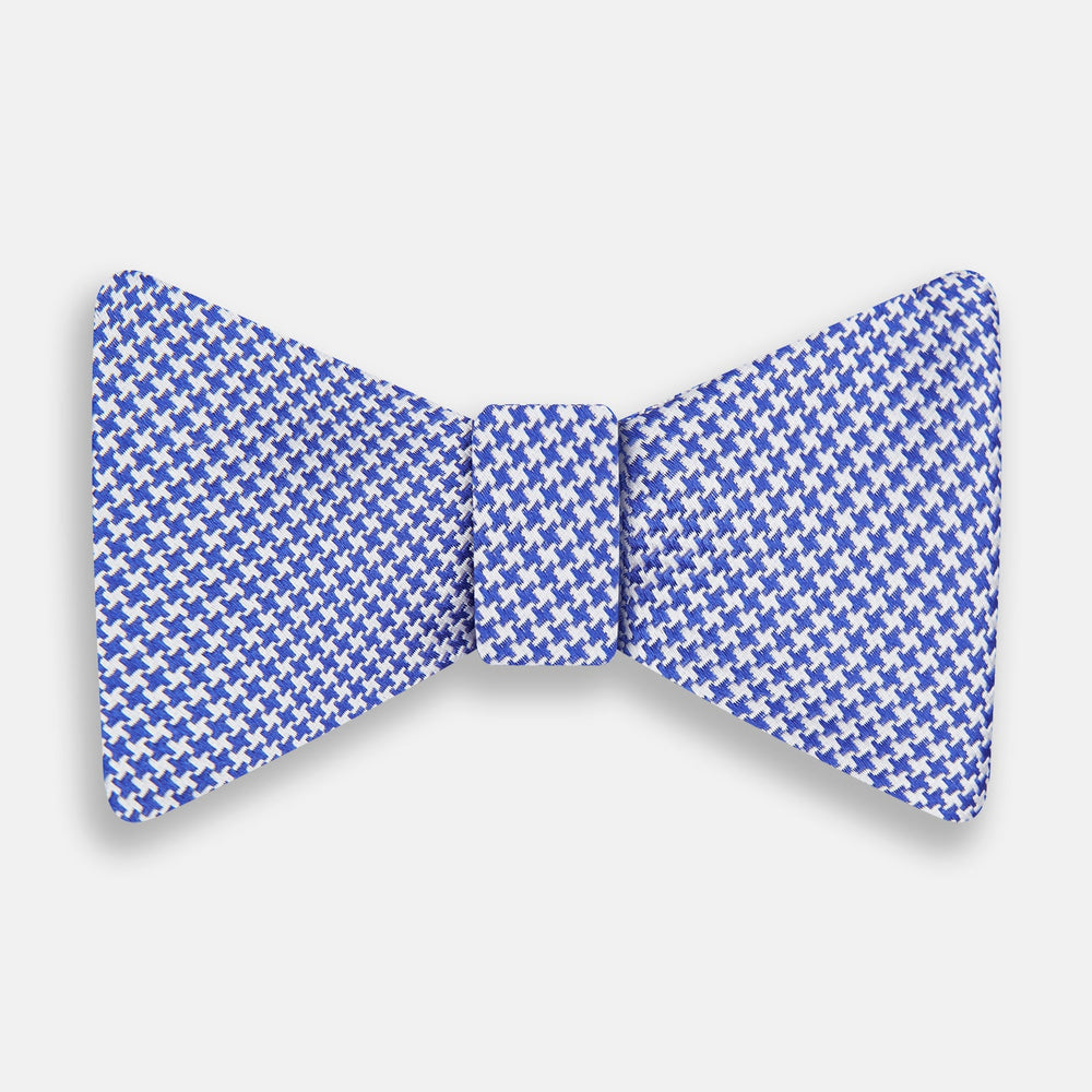 The Turnbull & Asser Navy and White Houndstooth Silk Bow Tie features a neatly centered knot, shown on a white background—an elegant formalwear accessory.