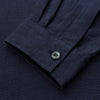 View 3 of product The Turnbull & Asser Navy Hemp Holiday Fit Winnington Shirt is a long-sleeve, button-up shirt with a single chest pocket, shown laid flat on a white background.