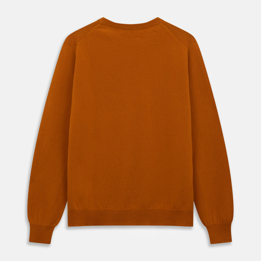 The Turnbull & Asser Rust Glenn Crew Neck Jumper is a plain, long-sleeved Scottish knitwear piece with ribbed cuffs and hem, shown laid flat on a white background.