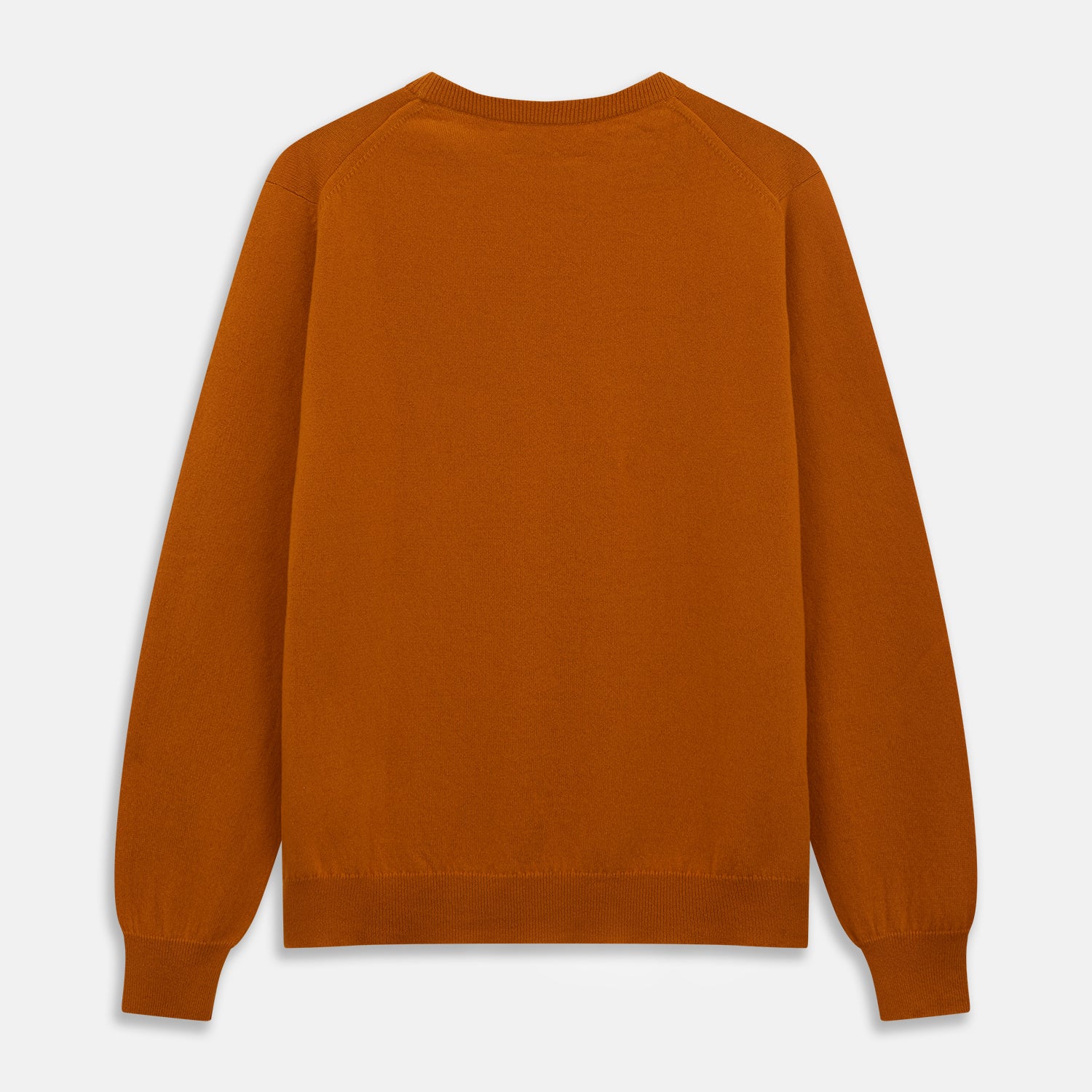 View 3 of product The Turnbull & Asser Rust Glenn Crew Neck Jumper is a plain, long-sleeved Scottish knitwear piece with ribbed cuffs and hem, shown laid flat on a white background.