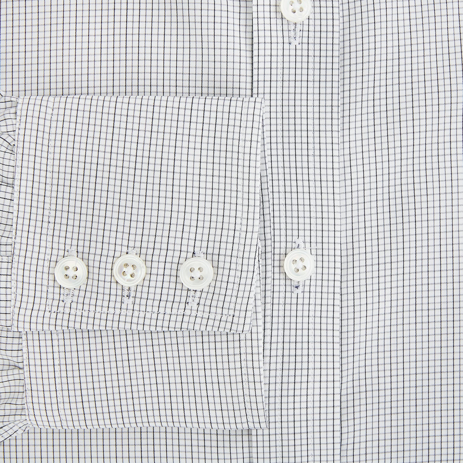View 4 of product A tailored-fit Turnbull & Asser Mayfair Shirt in midnight blue with a grid check pattern, spread collar, and buttoned cuffs, crafted from premium Italian cotton and laid flat on a white background.