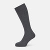 View 1 of product The Ash Mid-Length Sock by Turnbull & Asser, shown upright on a plain white background, is a single dark gray ribbed knee-high made from mercerised Egyptian cotton.
