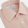 View 2 of product The Orange Micro Shadow Check Mayfair Shirt by Turnbull & Asser features a T&A collar, button-down front, and buttoned cuffs; crafted from Italian cotton in an orange and white check pattern, laid flat on a white background.