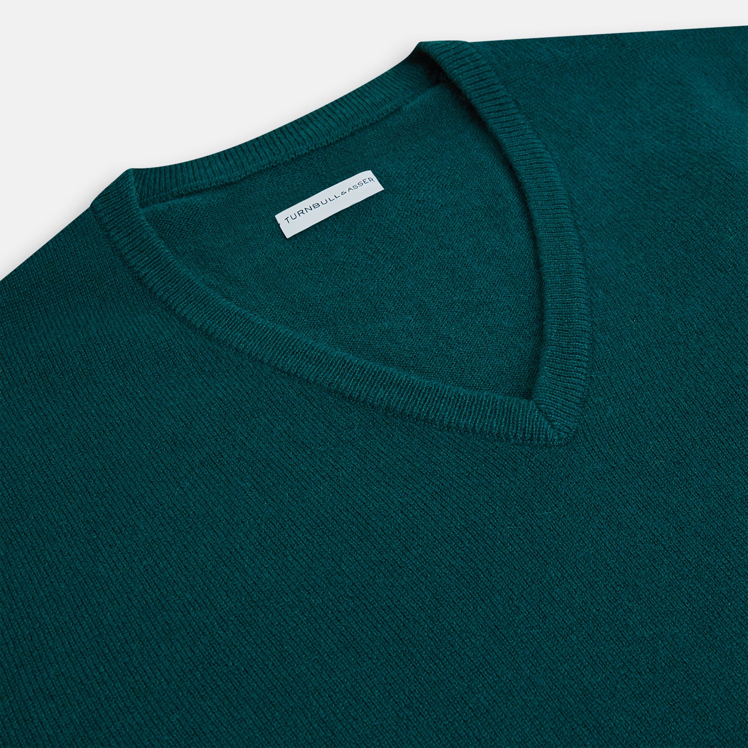 View 2 of product The Moss Green Cashmere V-Neck Jumper by Turnbull & Asser features long sleeves with ribbed cuffs and hem, shown on a plain white background.