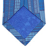 View 4 of product The Turnbull & Asser Blue Motif Printed Foulard Silk Tie showcases a geometric pattern in varying blue shades, making it a striking and essential accessory for any wardrobe.