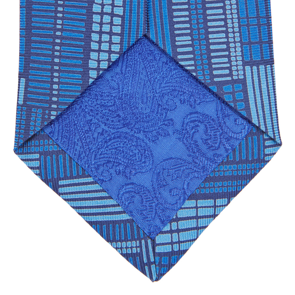 The Turnbull & Asser Blue Motif Printed Foulard Silk Tie showcases a geometric pattern in varying blue shades, making it a striking and essential accessory for any wardrobe.