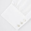 View 2 of product The Turnbull & Asser Two-Fold 120 White Shirt with a Regent collar and 3-button cuffs is neatly folded and displayed against a light blue background.