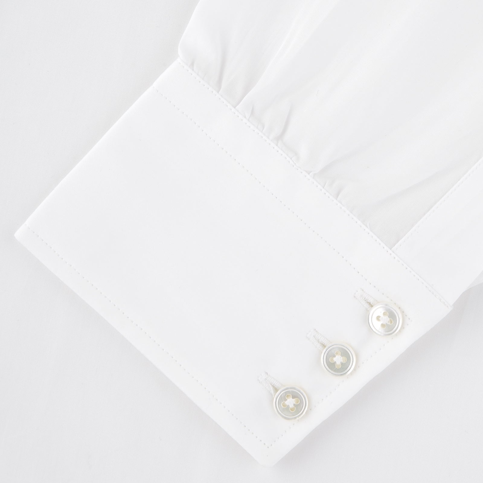 View 5 of product The Turnbull & Asser Two-Fold 120 White Shirt with a Regent collar and 3-button cuffs is neatly folded and displayed against a light blue background.