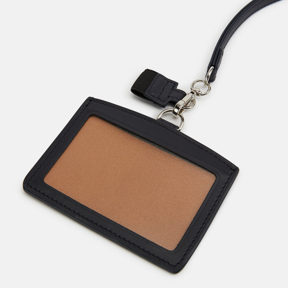 The Turnbull & Asser Navy ID Card Holder is shown with a matching lanyard strap and key cover, all featuring silver hardware, against a plain white background.