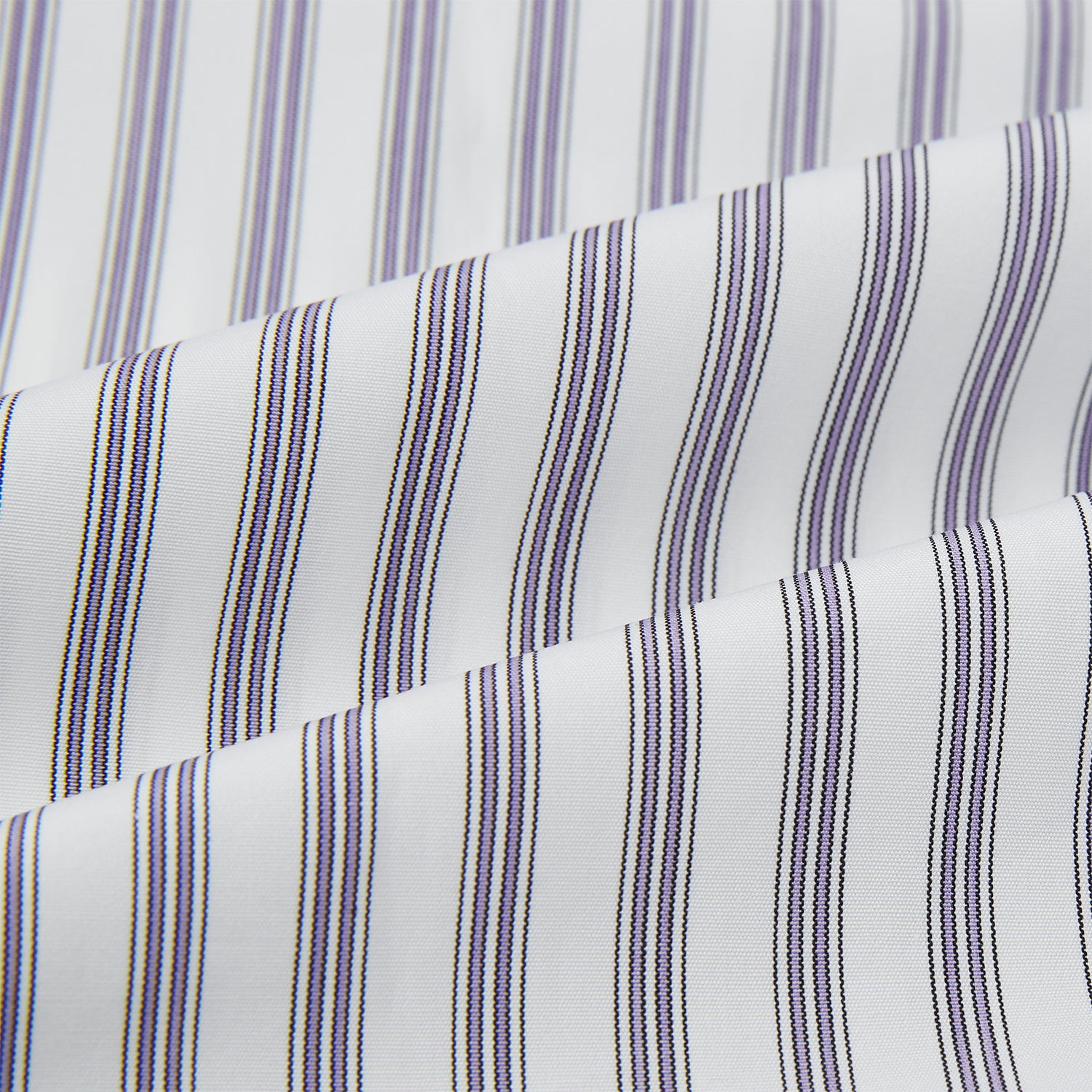 View 5 of product The Turnbull & Asser Purple Multi Stripe Quarzo Nightshirt features a collared, button-front design with a chest pocket and vertical white and light gray stripes, shown laid flat on a white background.