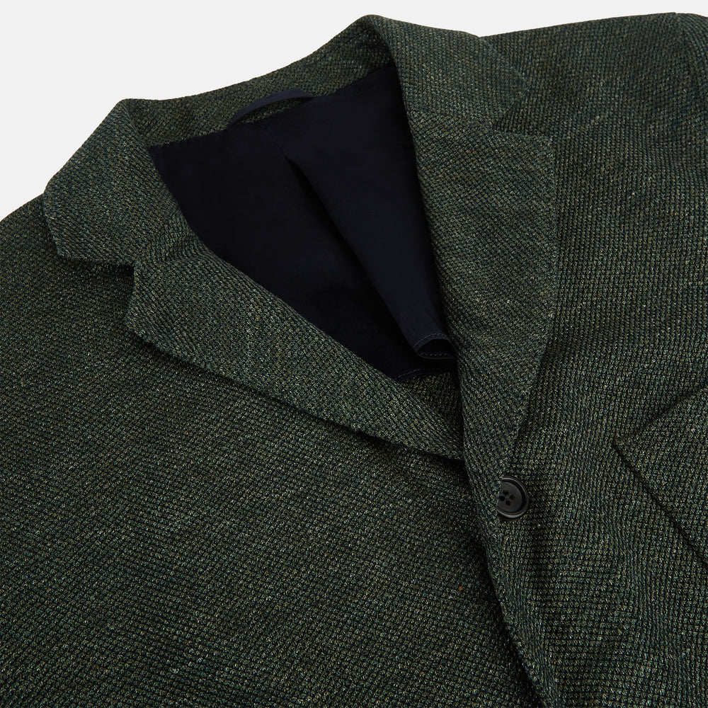 The Turnbull & Asser Forest Green Linen Blend Cambridge Blazer features British tailoring with notch lapels, two front buttons, a chest pocket, and two lower pockets, displayed on a plain white background.