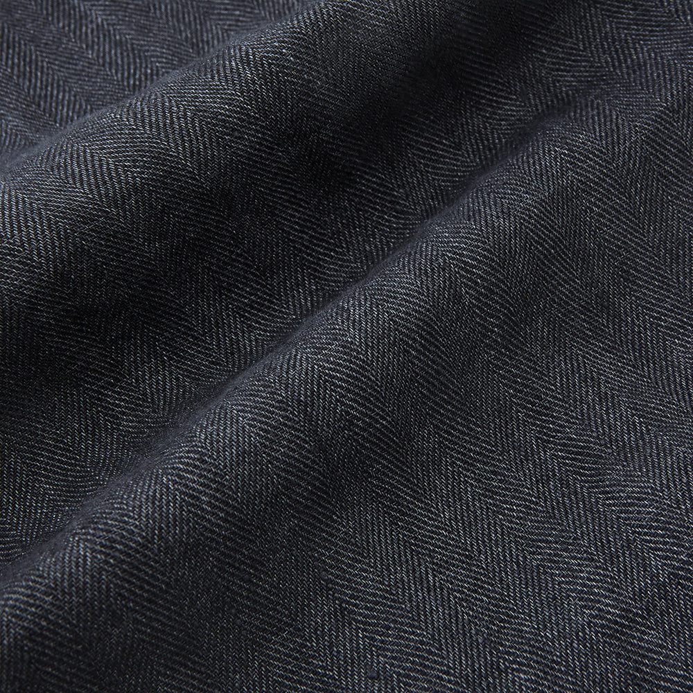 The Turnbull & Asser Ash Quilted Linen Herringbone Waistcoat is sleeveless and dark gray with a V-neck, two zippered side pockets, and a small chest pocket, shown on a plain white background.