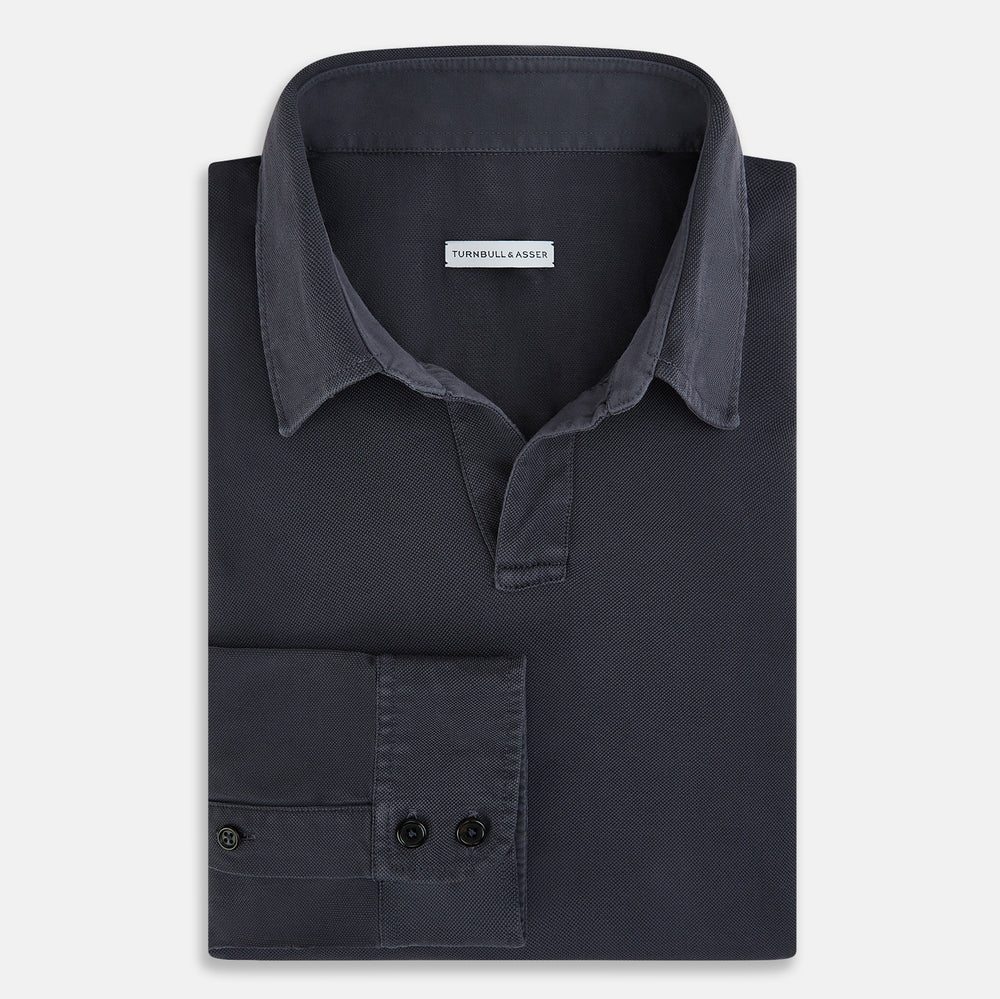 The Charcoal Rugby Polo Shirt by Turnbull & Asser is a pure cotton, long-sleeve polo in charcoal grey, featuring a collared open V-neck with no buttons, displayed flat on a white background.